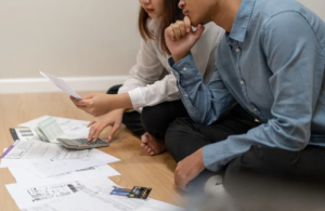 Man and woman looking at bills hoping to do debt consolidation