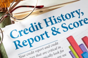 glasses on top of a piece of paper with the title: Credit Report, History & Score.